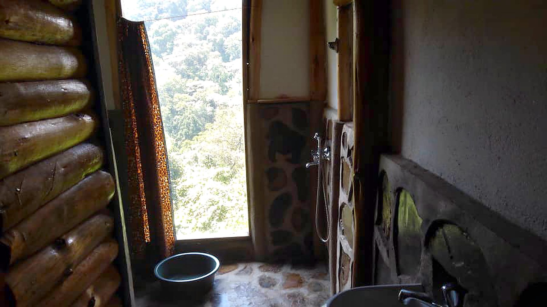 Forest framed by the window of a cabin bathroom