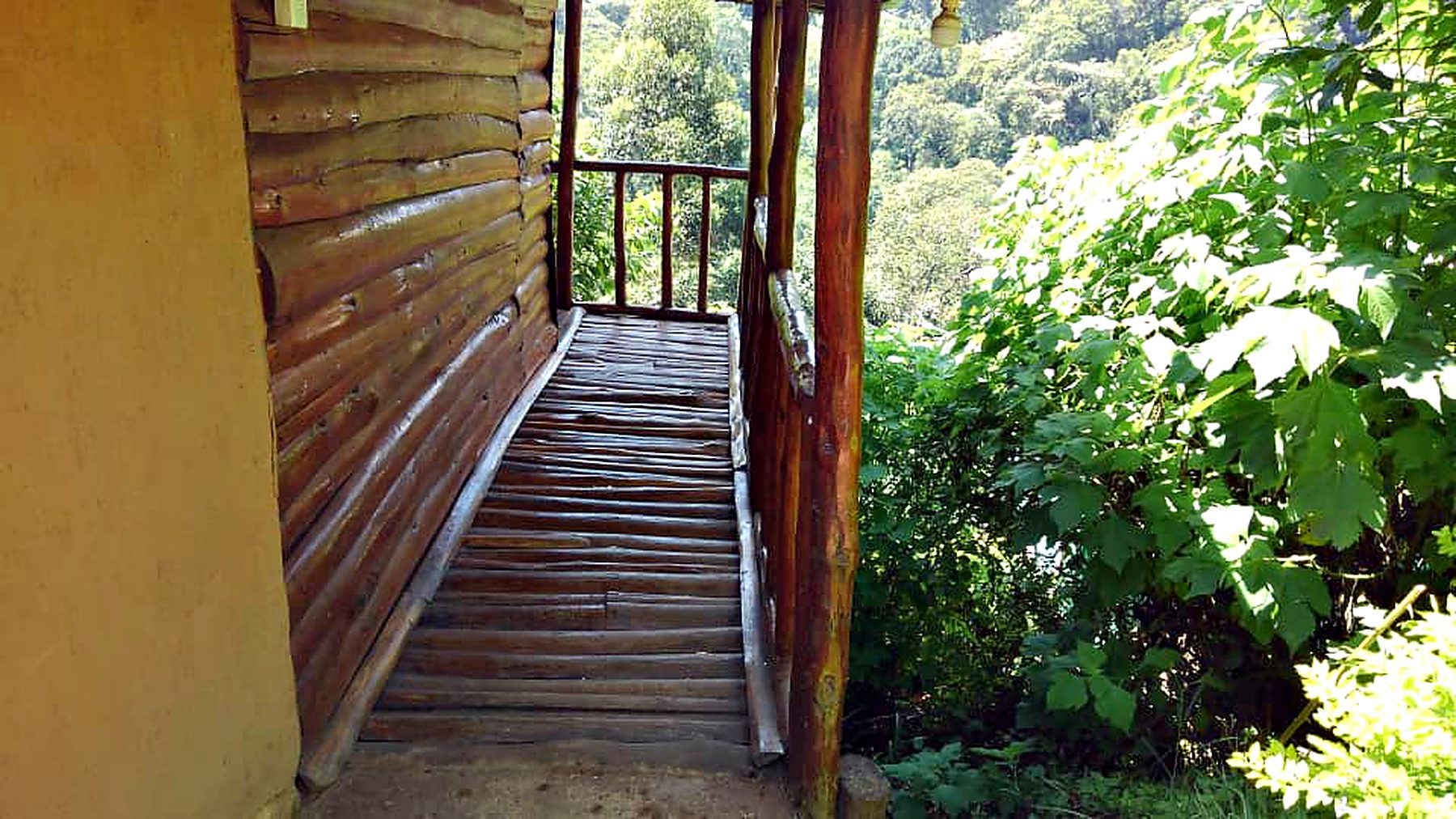 Timber walkway leading around a cabin