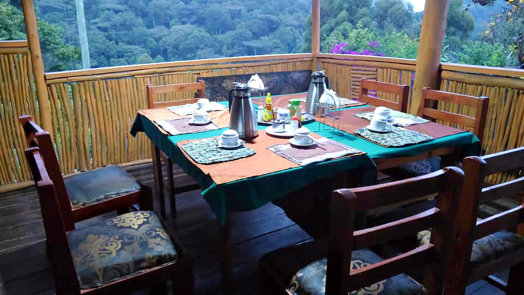 Breakfast laid out on the open dining deck above the forest